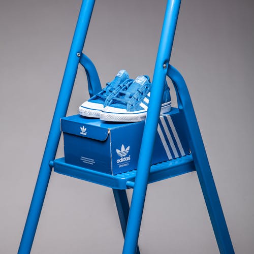 Free A Pair of Blue Sneakers in a Ladder Stock Photo