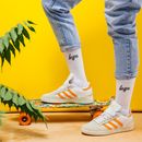 A Stylish Person Stepping on a Skateboard