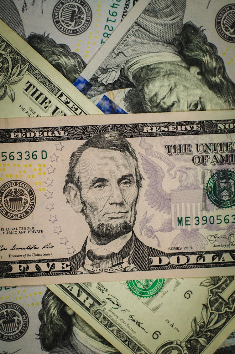 A Close-Up Of A Five Dollar Bill