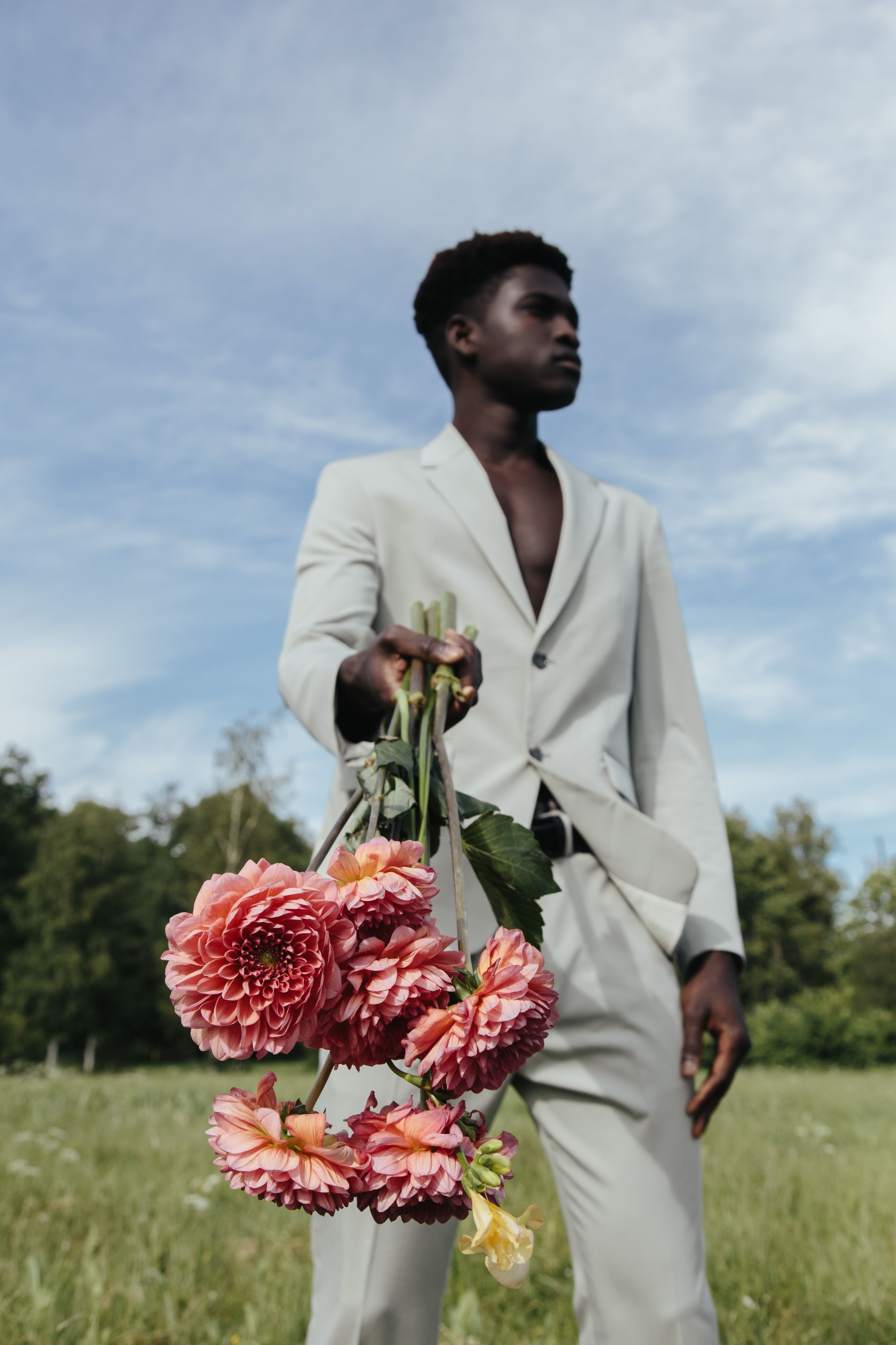 A Man in a Suit Holding Flowers · Free Stock Photo