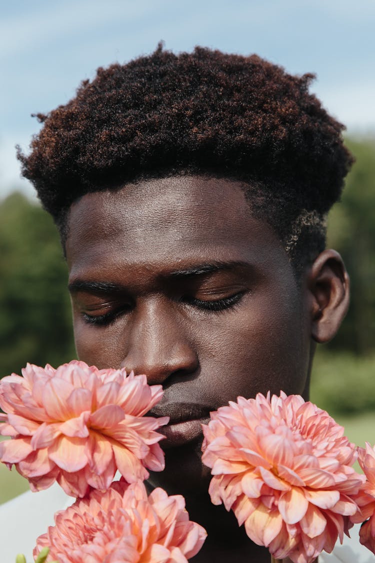 Man Smelling Flowers