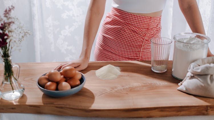 Woman Cooking With Eggs And Flour