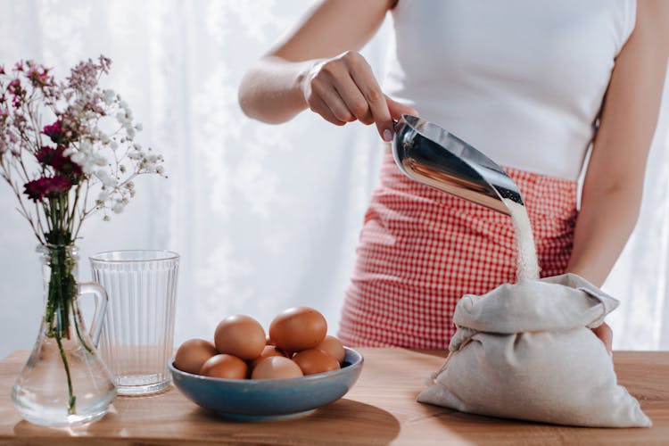 Woman Cooking With Eggs And Flour