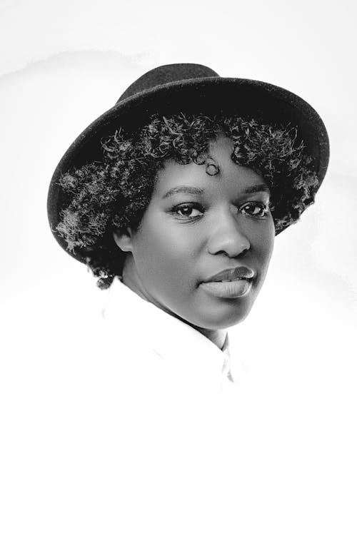 A Grayscale of a Woman Wearing a Hat