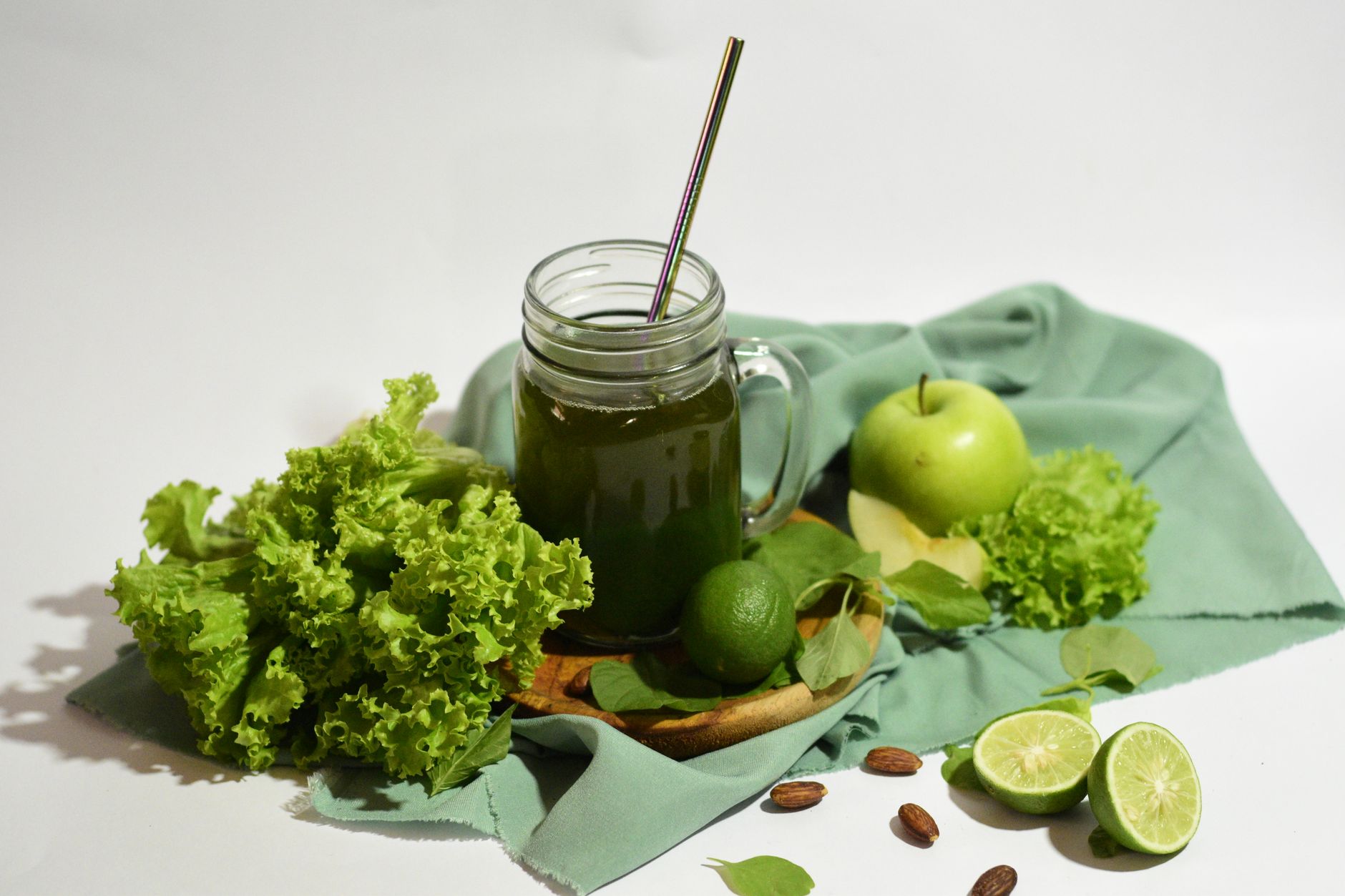 Fresh immunity shot poured into a glass with black pepper on a wooden table