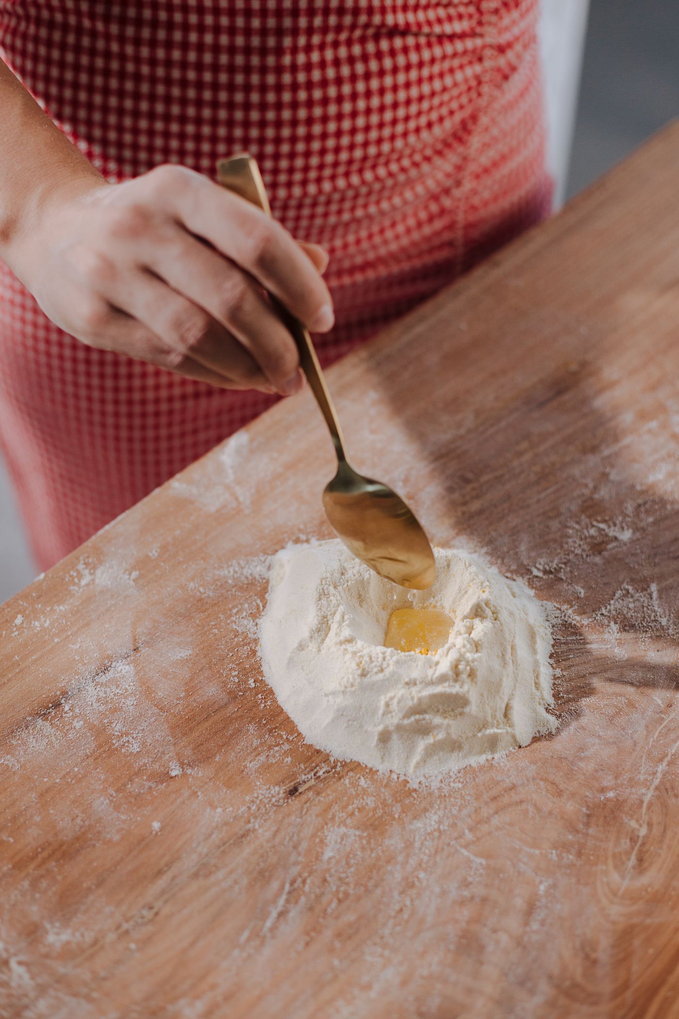 Homemade pastry ingredients being mixed on a wooden work surface