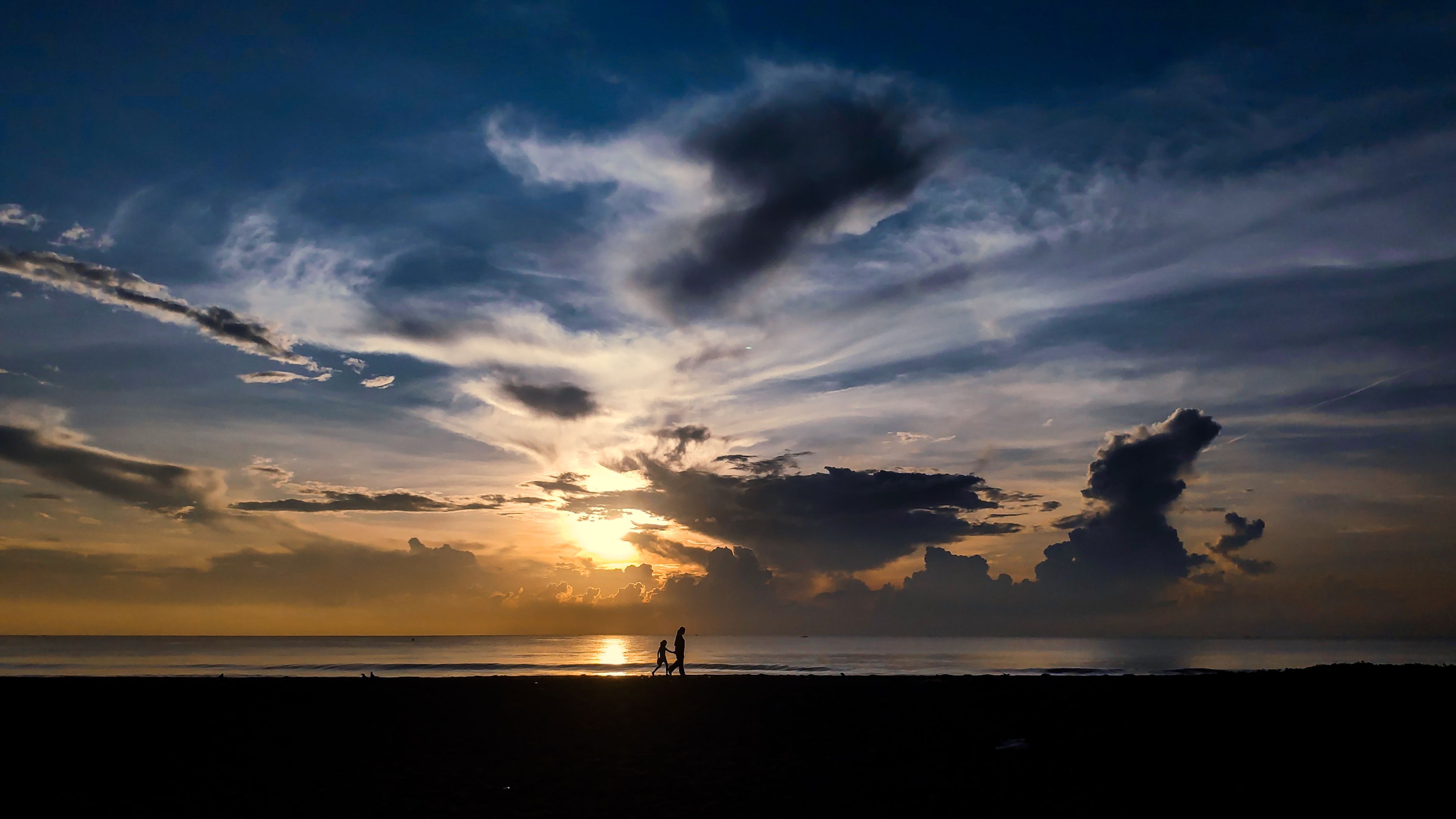 Silhouette of People Walking on the Beach during Sunset · Free Stock Photo