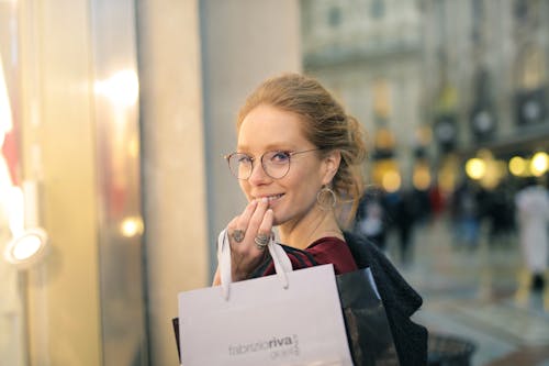 Close-Up Photography of a Woman Holding Paper Bags