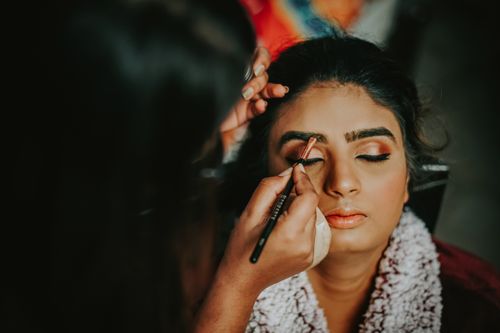 Free Close-up of a woman getting her makeup done, highlighting beauty and precision. Stock Photo