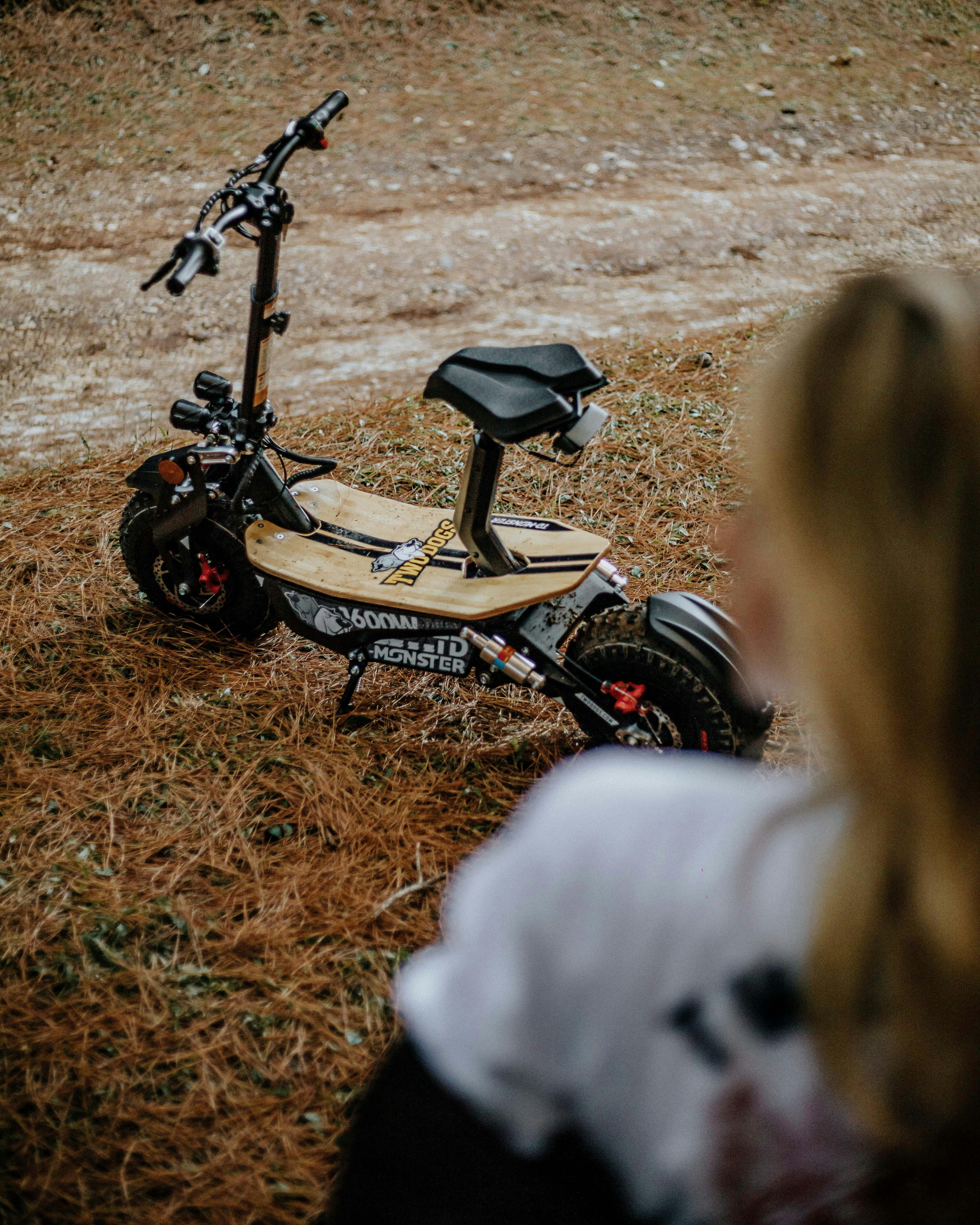 photograph of a scooter on dry grass