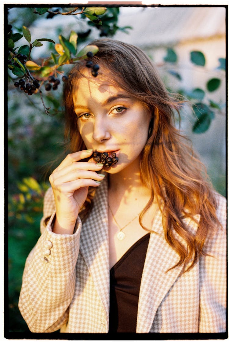 Woman Eating Berries Outside