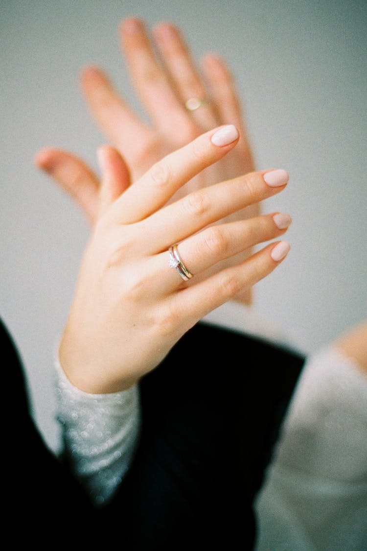 Close Up On Engagement Rings On Womans And Mans Hands