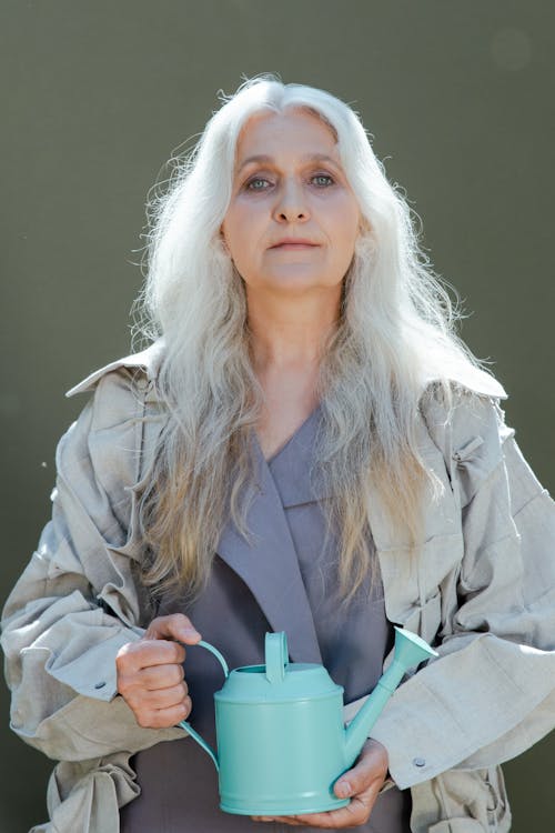 A Woman with Long Hair Holding a Watering Can