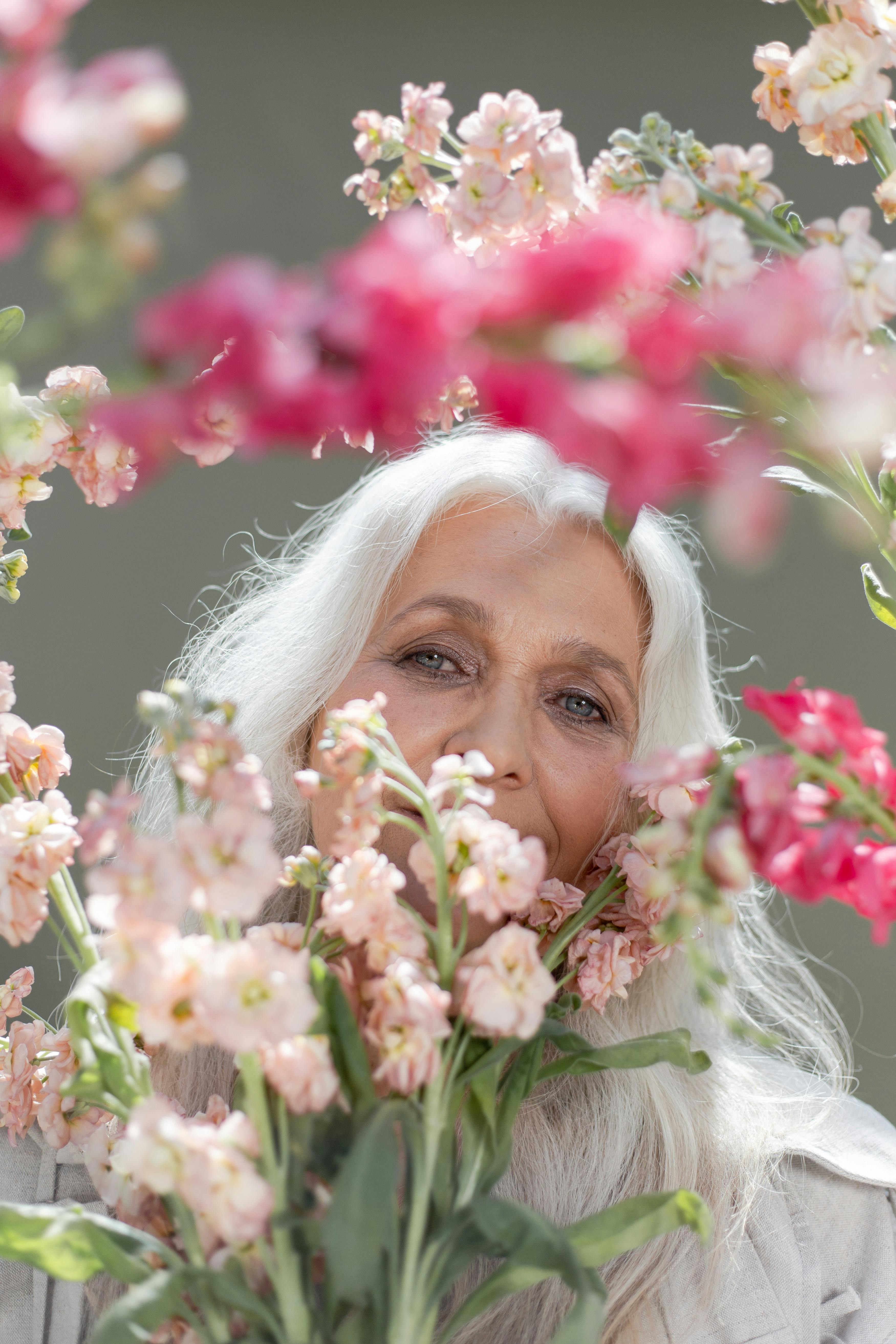 an elderly woman holding flowers