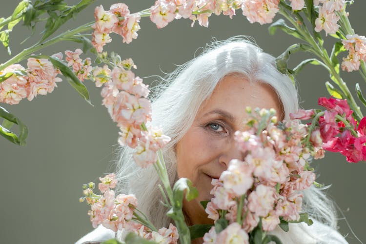 An Elderly Woman Holding Flowers