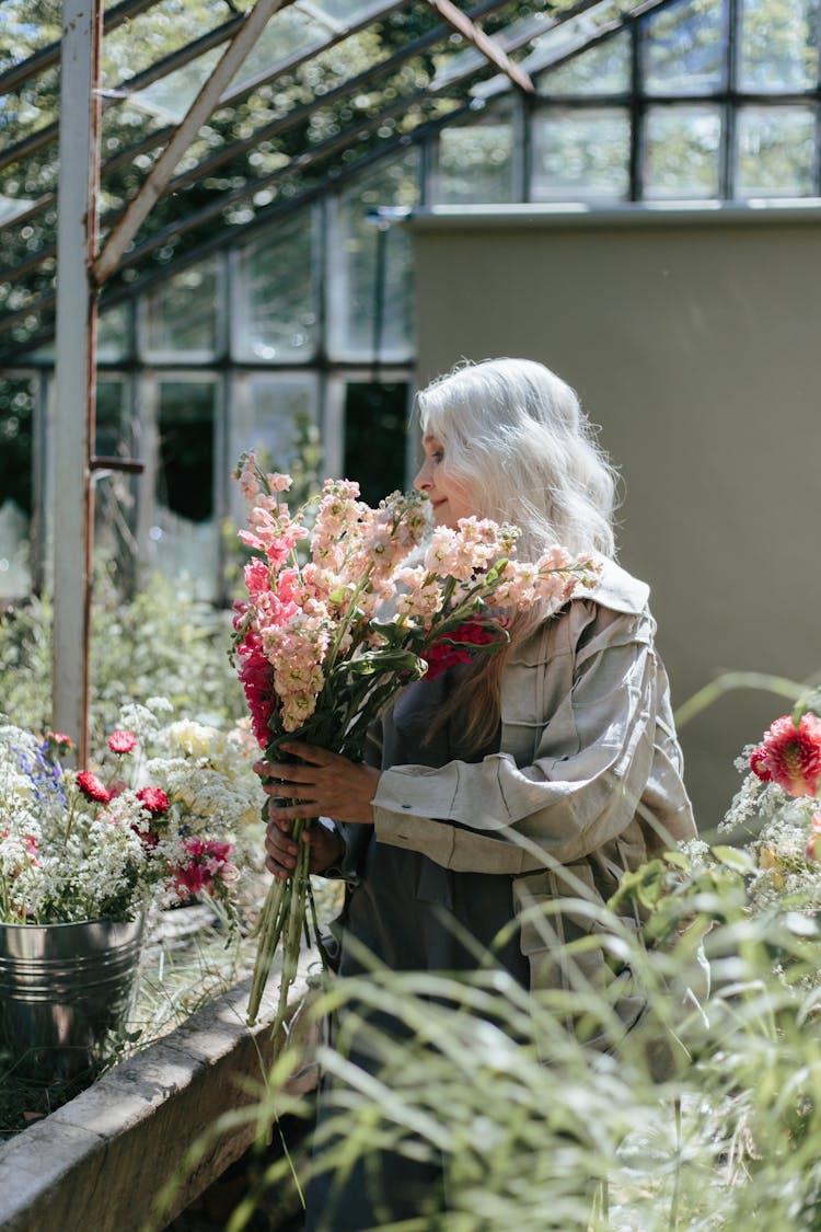 An Elderly Woman Holding Flowers