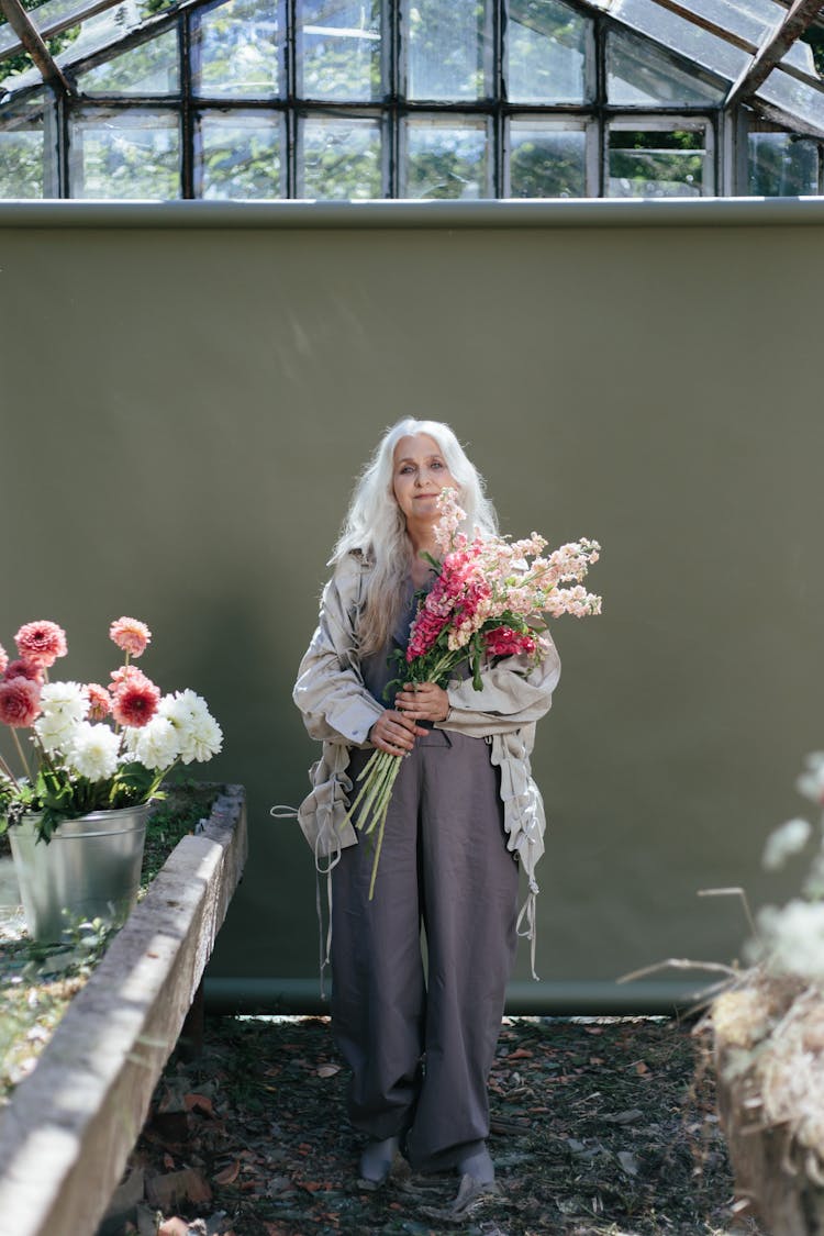 An Elderly Woman Holding Flowers