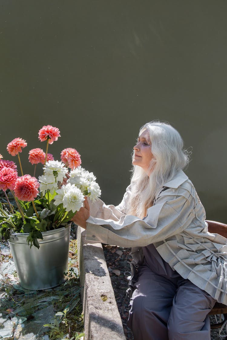 An Elderly Woman Holding Flowers