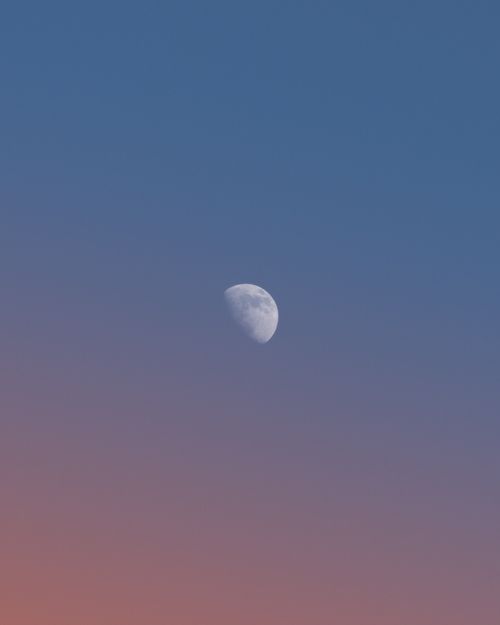Free Capture of the moon in a vibrant dusk sky over Luxembourg, blending deep blue with pink hues Stock Photo