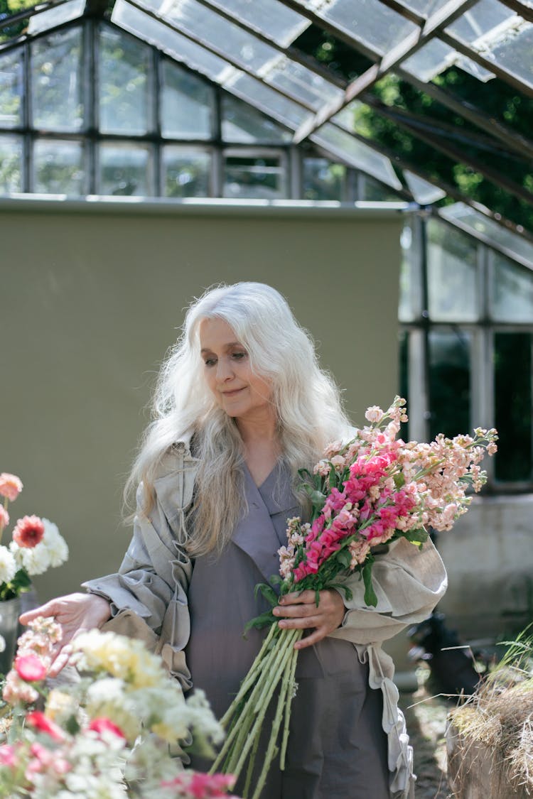 An Elderly Woman Holding Flowers