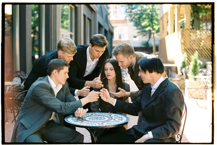 Photograph Of Men Holding Fire To Womans Cigarette