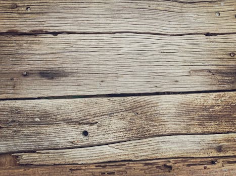 Close-up view of weathered wooden boards showcasing intricate grain and rustic texture.