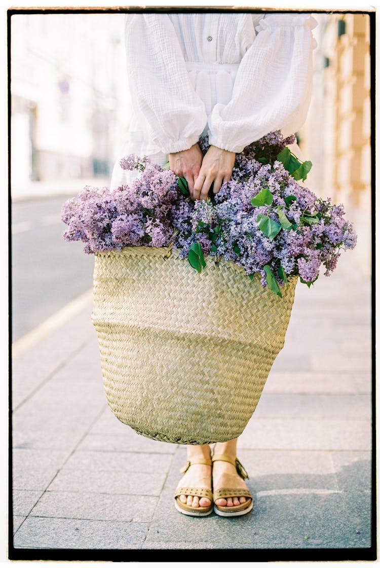 Photograph Of Woman Holding Big Basket With Flowers