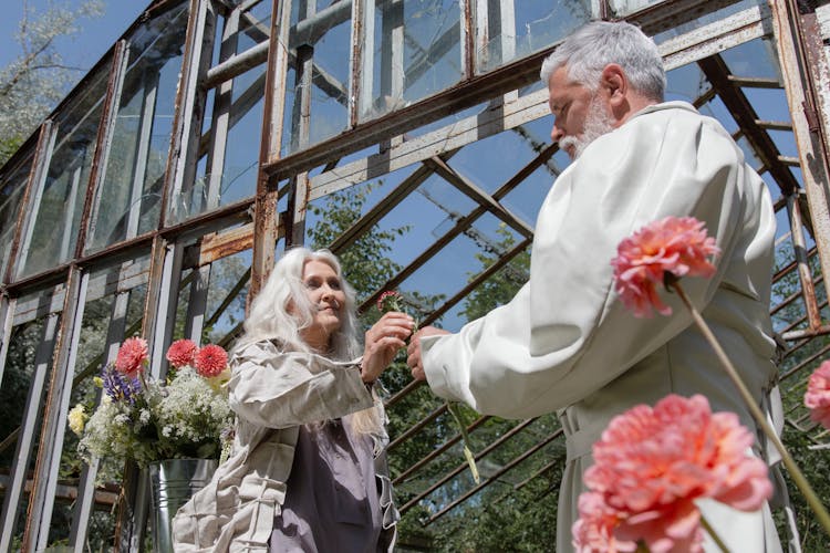 A Man Giving A Flower To A Woman 