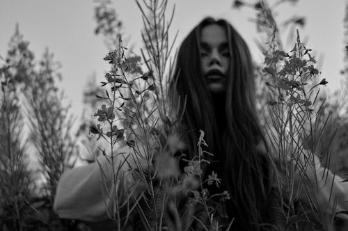 
A Grayscale of a Woman in a Field