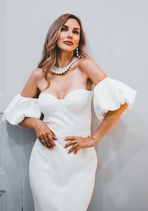Free 
A Woman Wearing a White Dress and Pearl Accessories Stock Photo