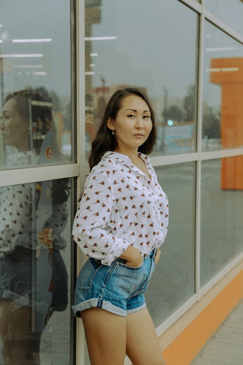 A Woman Wearing a White Long Sleeves and Denim Shorts