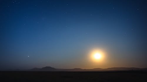 Free Bright Moon on a Night Sky over Mountains Stock Photo