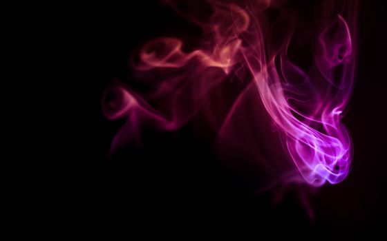 Colorful smoke patterns creating an abstract design on a black background.