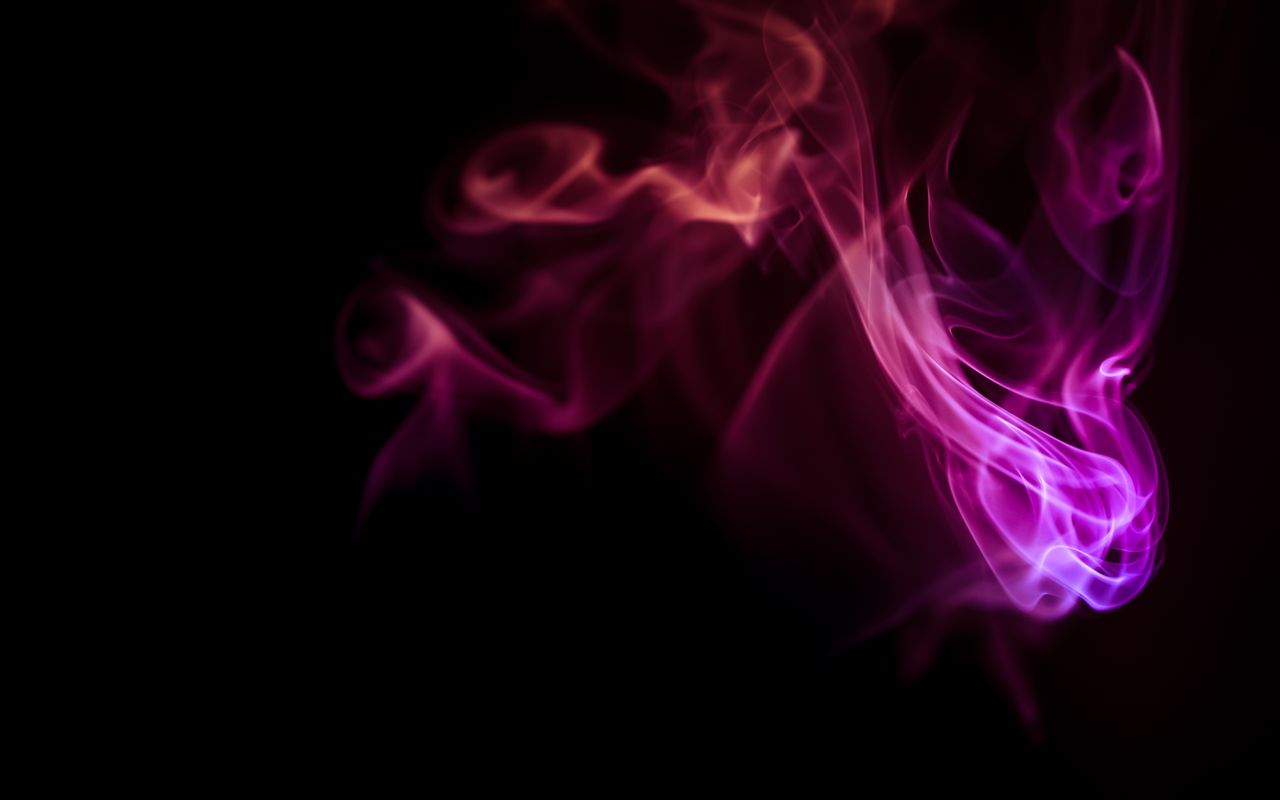 colorful smoke patterns creating an abstract design on a black backgro