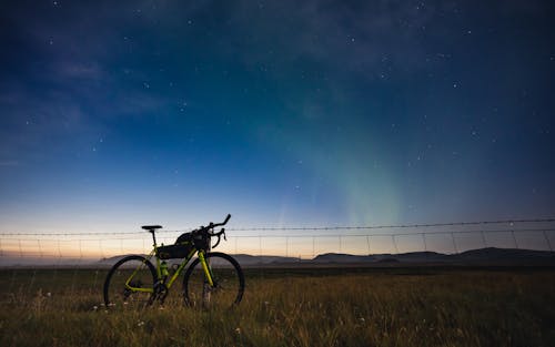 A Mountain Bike on Brown Grass Field during Night Time