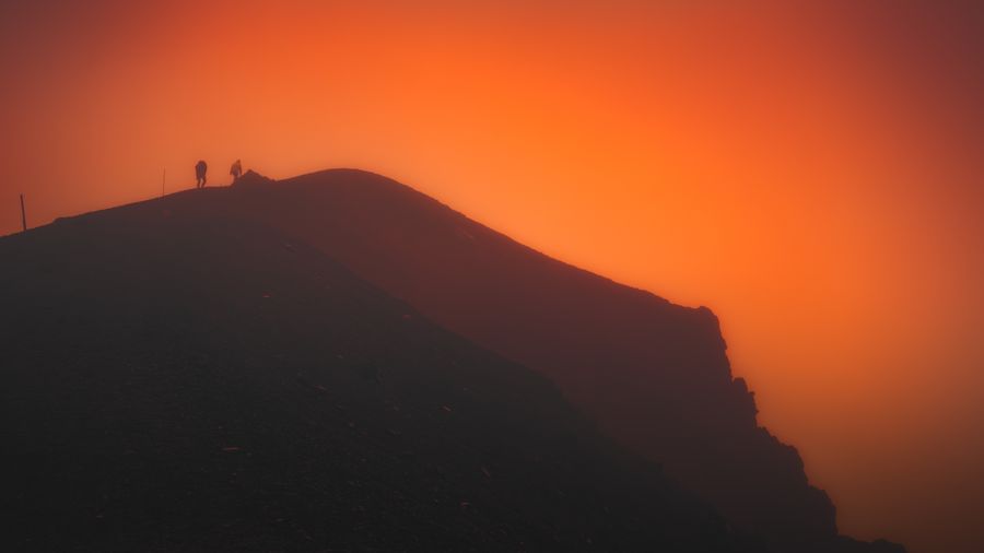 Season artwork — two hikers silhouetted on a ridge at sunset, photo by Marek Piwnicki on Pexels