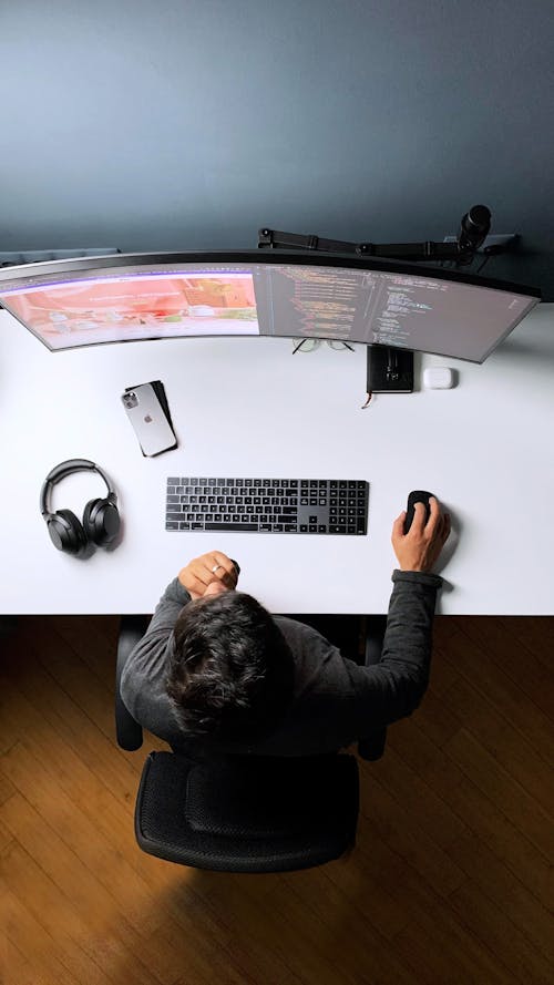 Free 

A Top View of a Person Working on a Computer Stock Photo