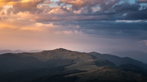 Free Dramatic sunset over Bieszczady Mountains in Podkarpackie Voivodeship, Poland. Lush landscapes and rolling hills. Stock Photo
