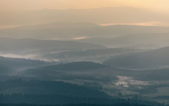 Serene view of misty mountain ranges in Podkarpackie Voivodeship, Poland at sunrise.. serene, view, misty