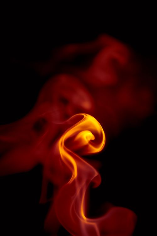 Free Intense abstract image of swirling flame against a dark background. Stock Photo