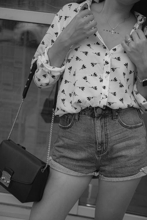 A Person in White Floral Long Sleeve Shirt and Denim Shorts
