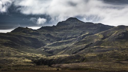 Free Dramatic mountain view in Iceland with dark clouds and rugged terrain. Stock Photo