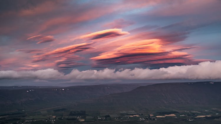 Illuminated Amazing Clouds Over Rolling Landscape