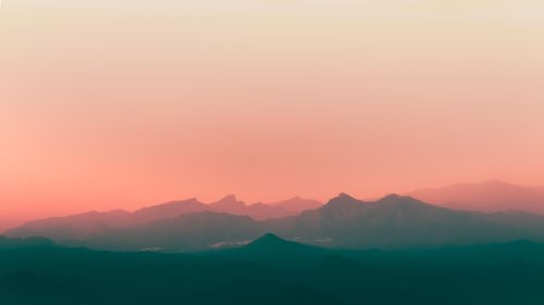 Free Majestic mountain range under a vibrant sunset with a misty atmosphere in Tenerife. Stock Photo