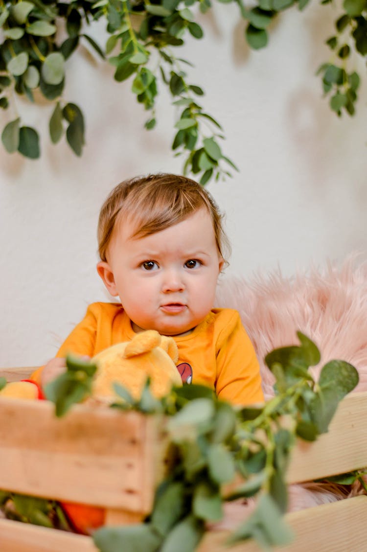 Baby Sitting On A Wooden Crate