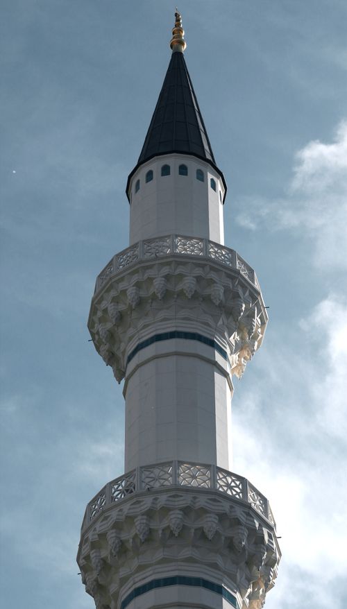Free A striking minaret captured against a bright blue sky, showcasing intricate architectural details. Stock Photo