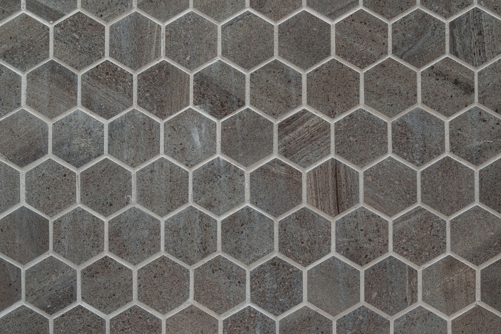 Gray hexagonal stone floor tiles in a geometric pattern