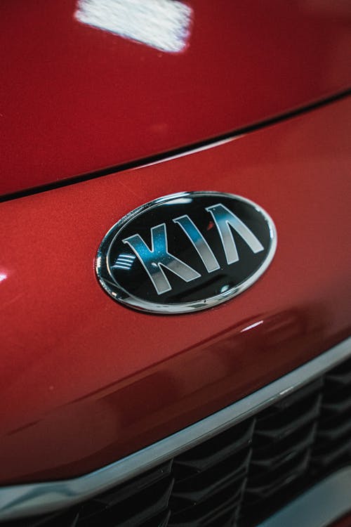 A Kia Emblem on a Red Vehicle