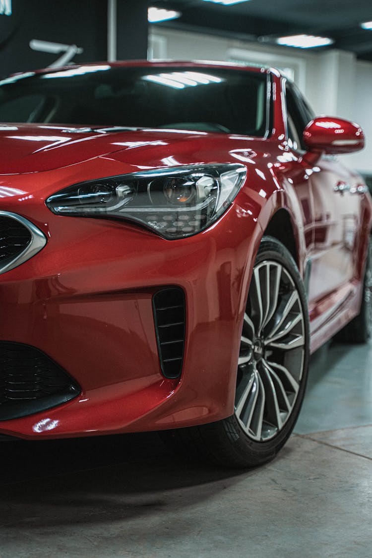 Photograph Of A Red Car's Headlight