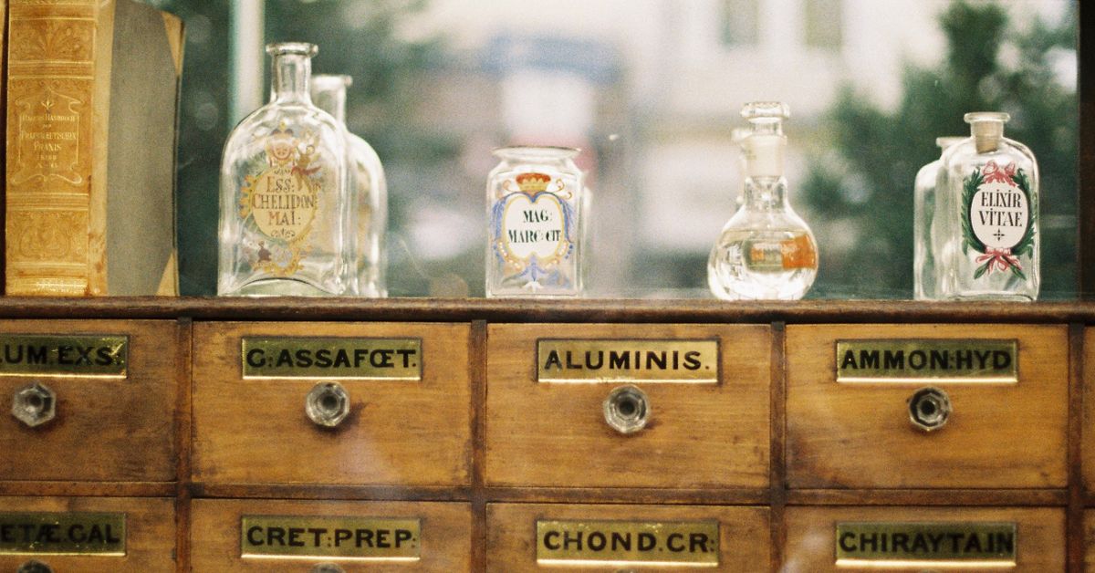 A wall of labelled wooden apothecary drawers